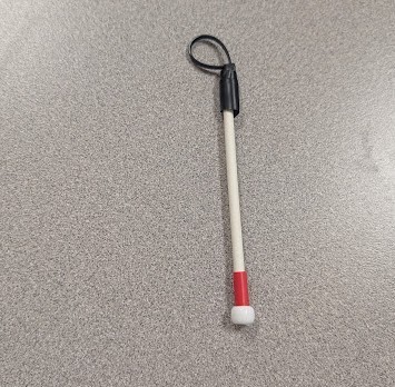 A white cane key chain made by a student for Grayson.  