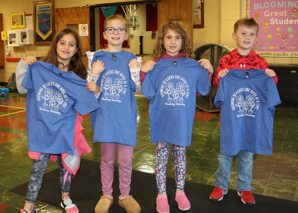 First graders show off their new t-shirts earned for reading 100 books.