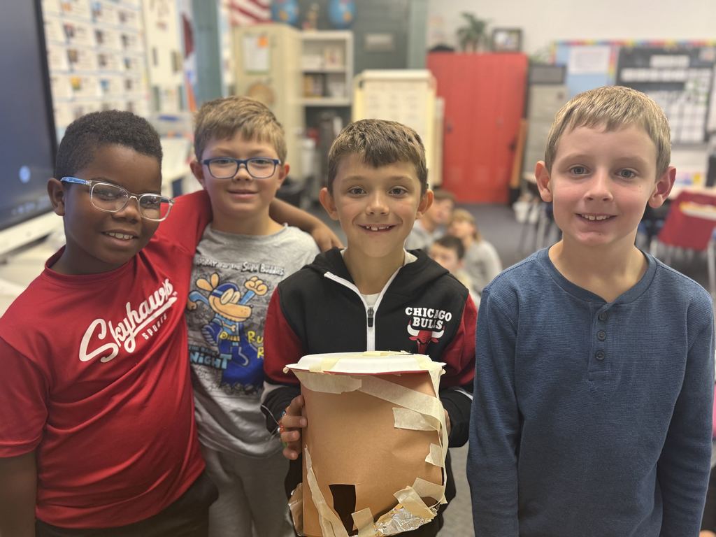 Broadway students learn about the strugglers of early settlers and pose with their projects.