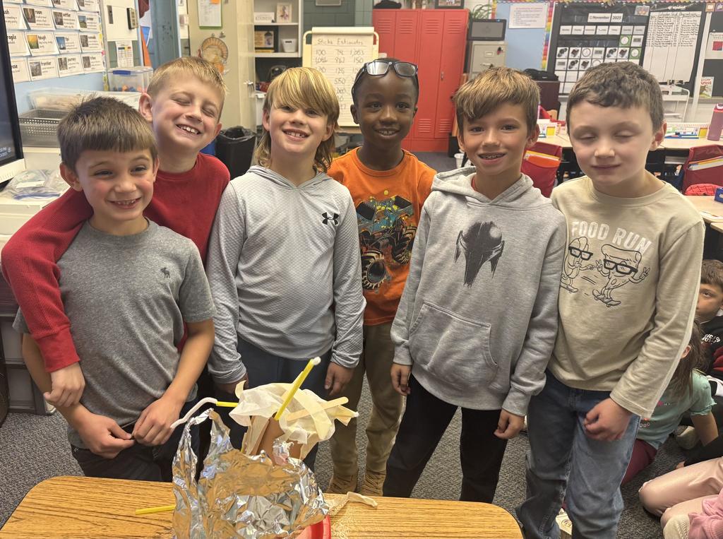 Broadway students learn about the strugglers of early settlers and pose with their project.