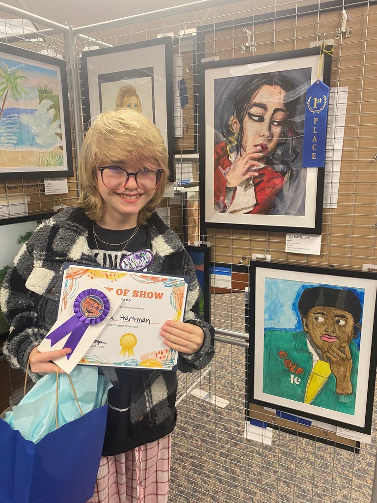 Isla Hartman stands near her award-winning art on display at the TCAAC show.