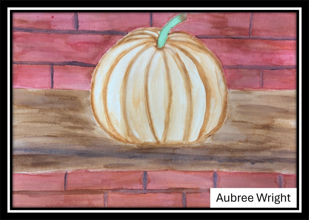 Student artwork featuring a pumpkin against a brick backdrop.