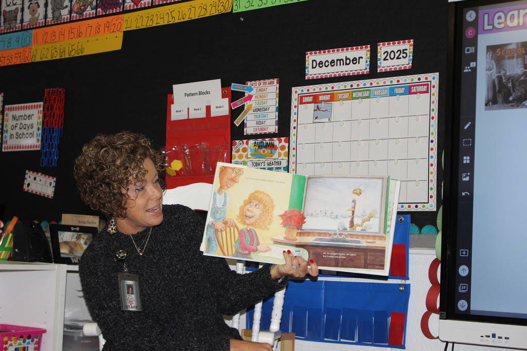 Broadway principal reading to students. 