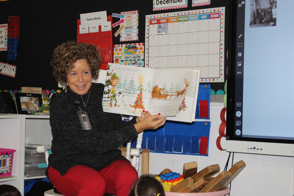 Broadway principal reading to students. 