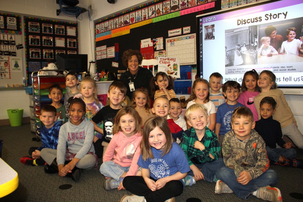 Broadway principal posing with students. 