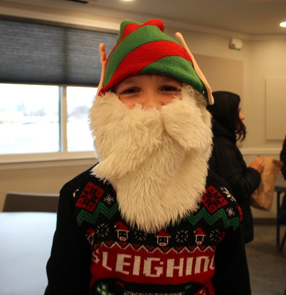 L.T. Ball 5th graders sing some holiday music for members of the Tipp Senior Center.  This student has a beard and elf hat.  
