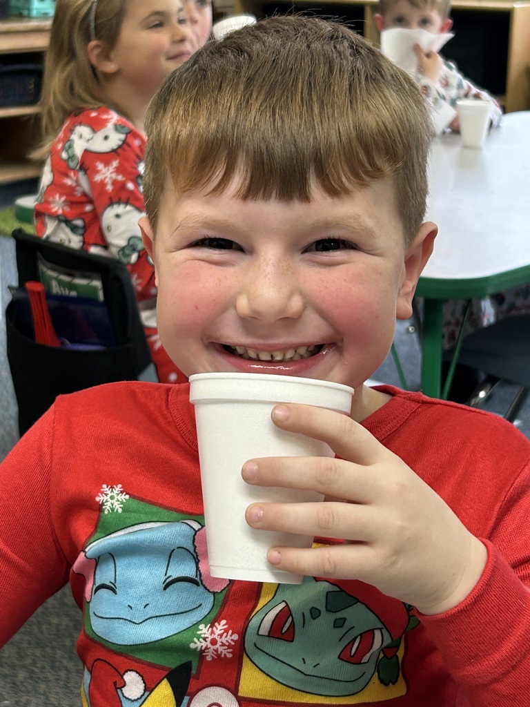 Mr. G the conductor from Polar Express deliver hot chocolate to kindergarten students.