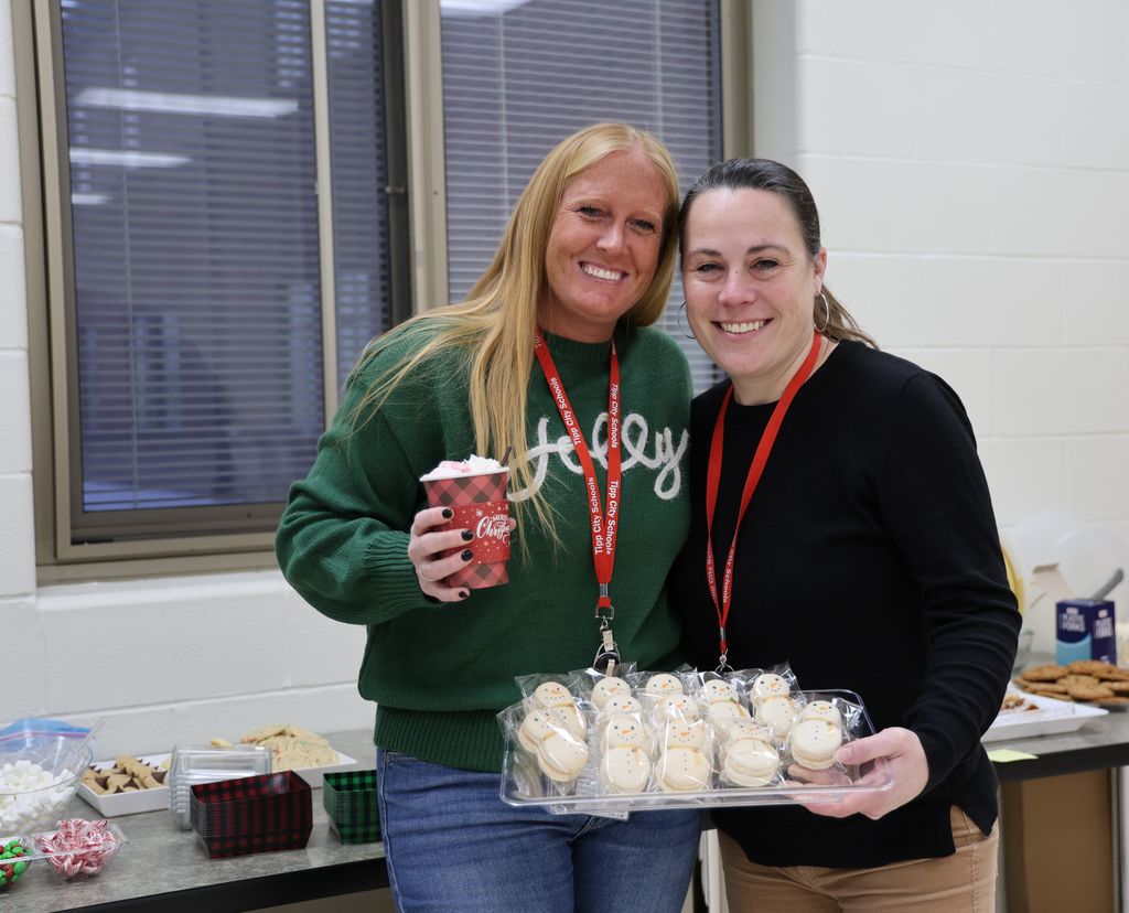 Mrs. Weaver and Ms. Everhart show off the homemade snowmen cookies.