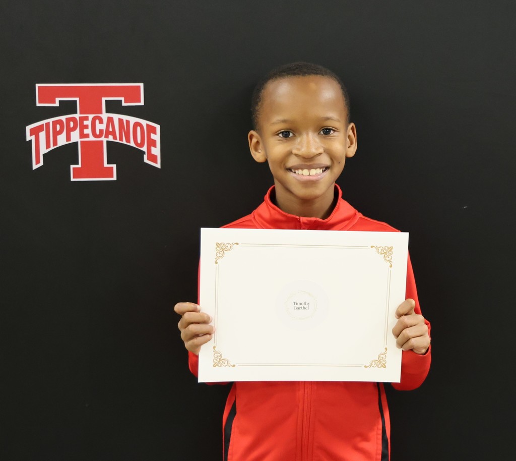 Broadway Elementary student holds his certificate after being recognized by the Board of Education.