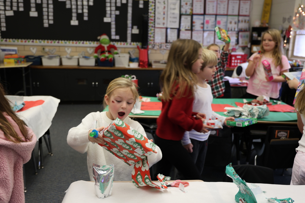 First graders show excitement during their puzzle gift exchange.