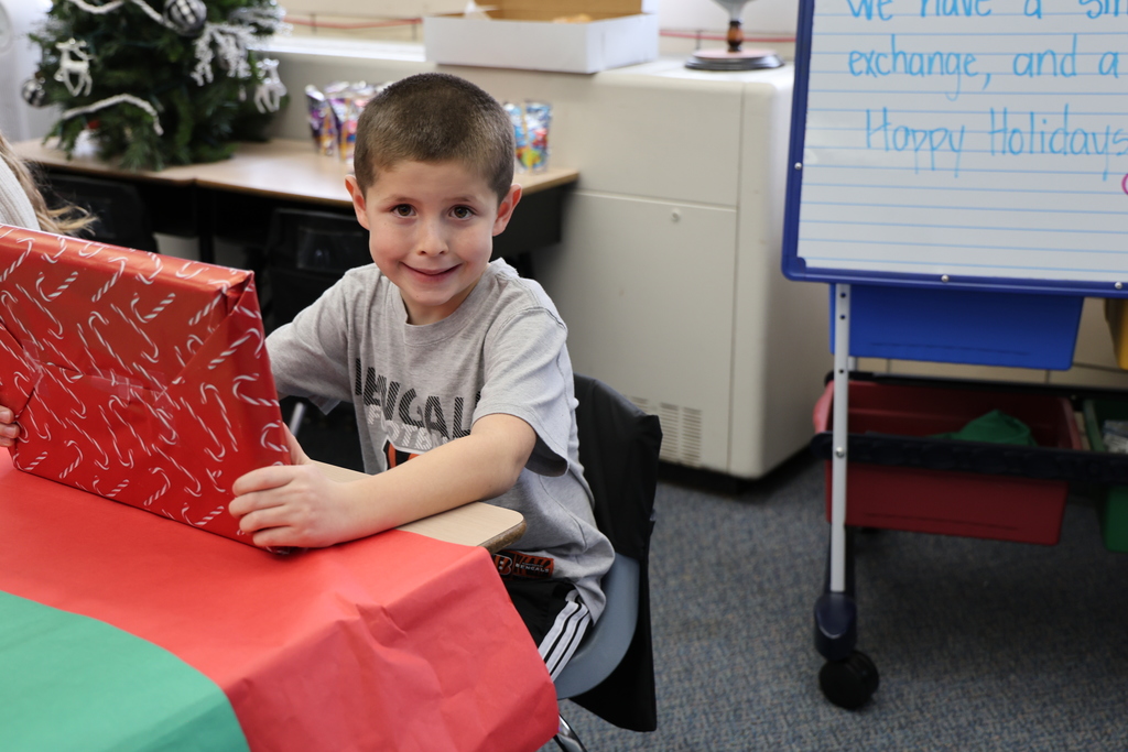 First graders show excitement during their puzzle gift exchange.