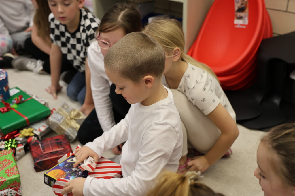 First graders show excitement during their puzzle gift exchange.