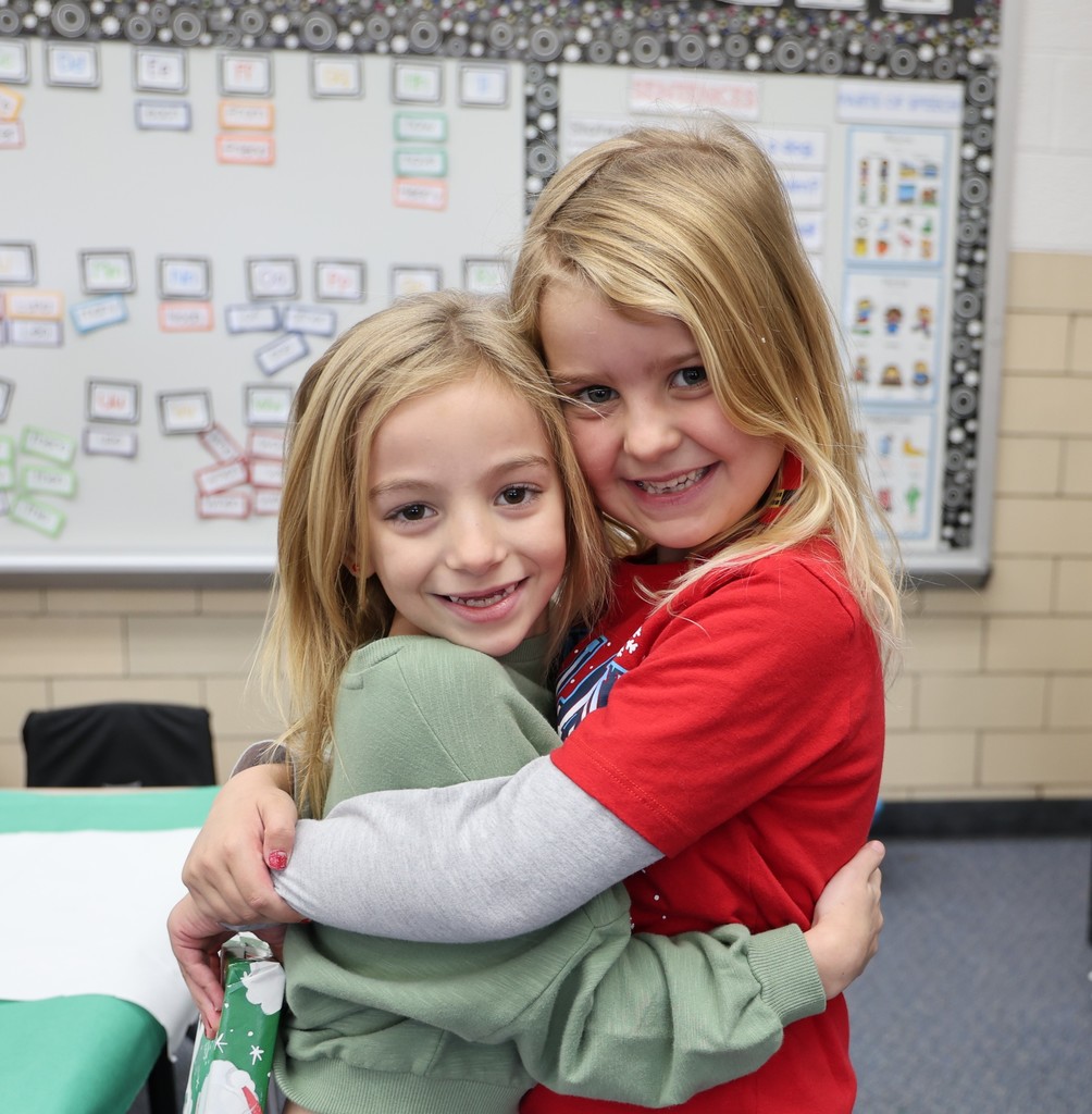 First graders show excitement during their puzzle gift exchange.