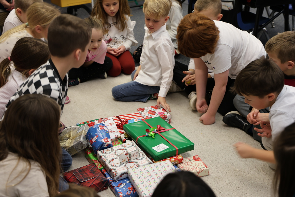 First graders show excitement during their puzzle gift exchange.
