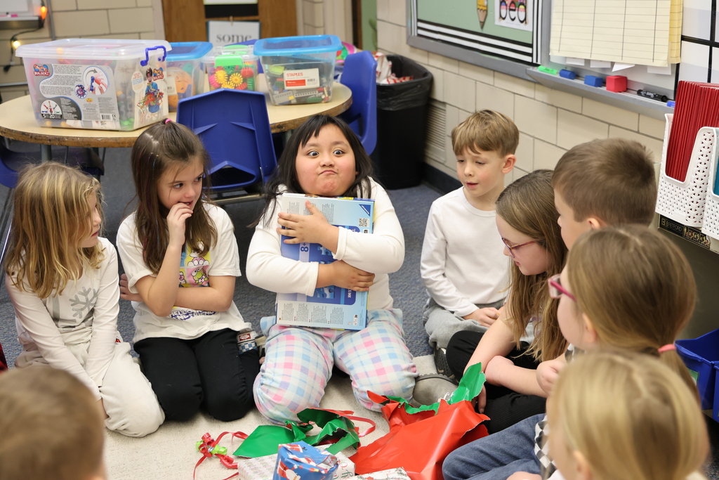 First graders show excitement during their puzzle gift exchange.