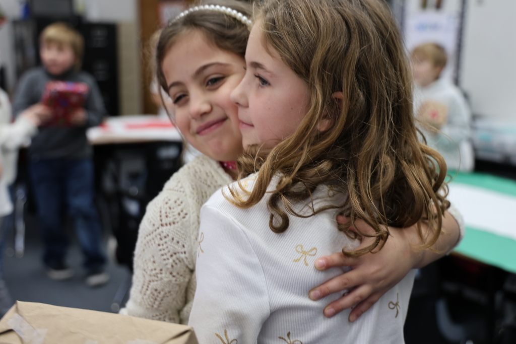 First graders show excitement during their puzzle gift exchange.