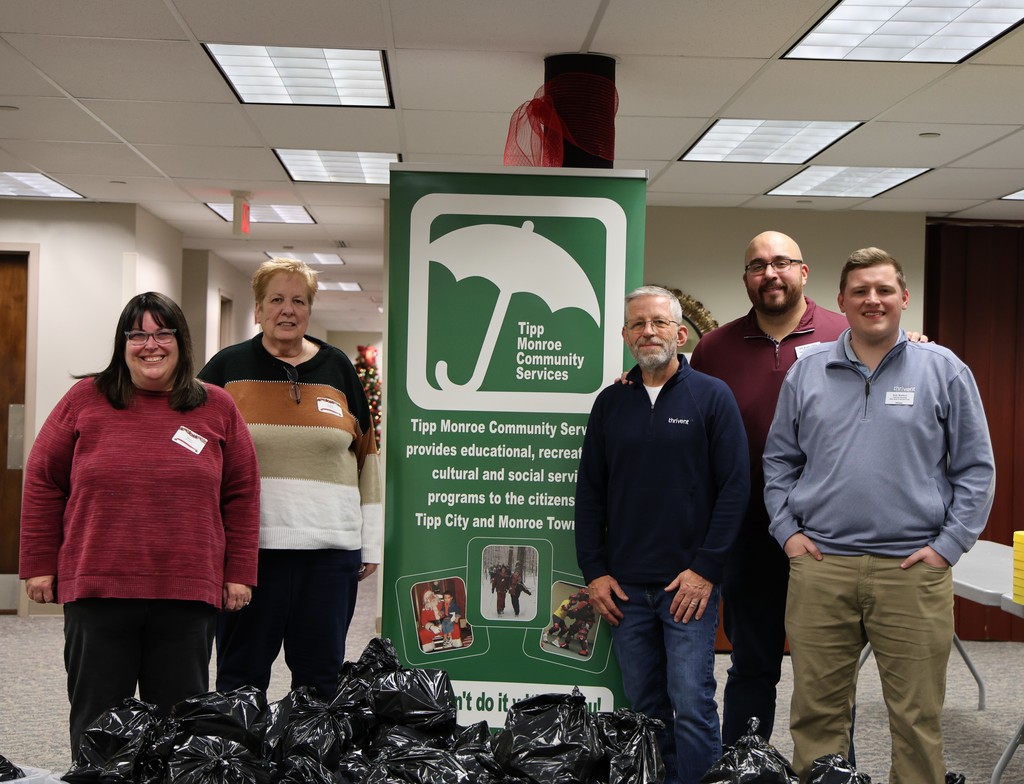 Thrivent and TMCS pose for a picture with the food bags for the Backpack Program.