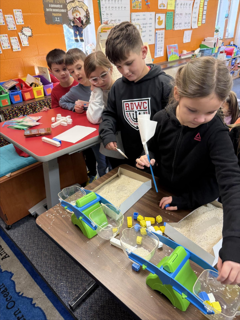 Second graders team up for a STEM activity.  