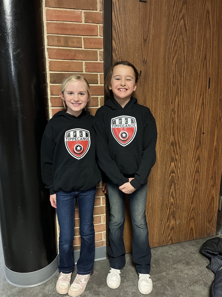 Two L.T. Ball girls in jeans, sneakers, and team sweatshirts for Twin Day.