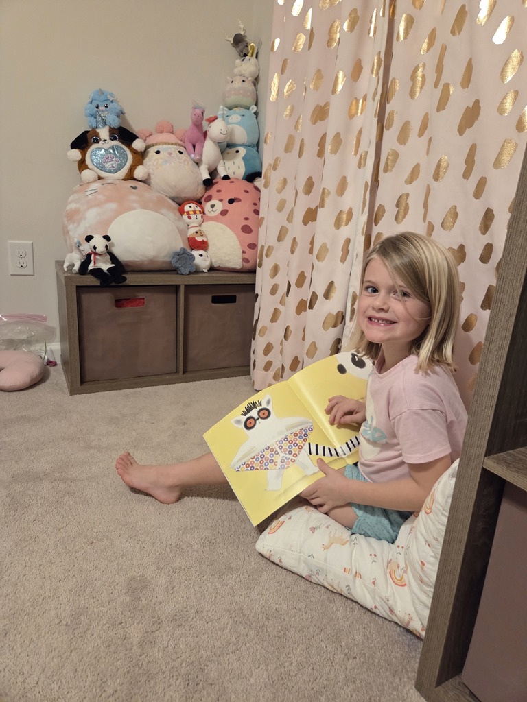A student is reading to her stuffed animals during the Online Learning Day.