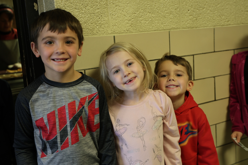 Happy students at Broadway Elementary wait patiently in line. 