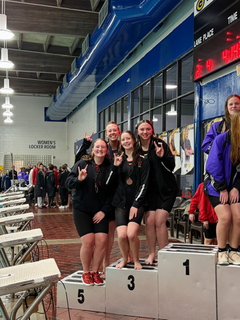 THS girls swim team on the podium.