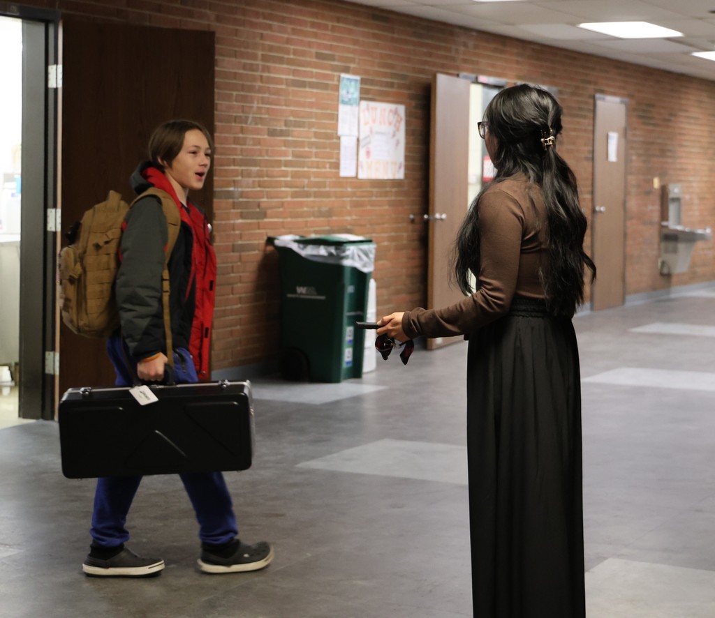 Maria Lozoya with a student who  is saying good morning.  