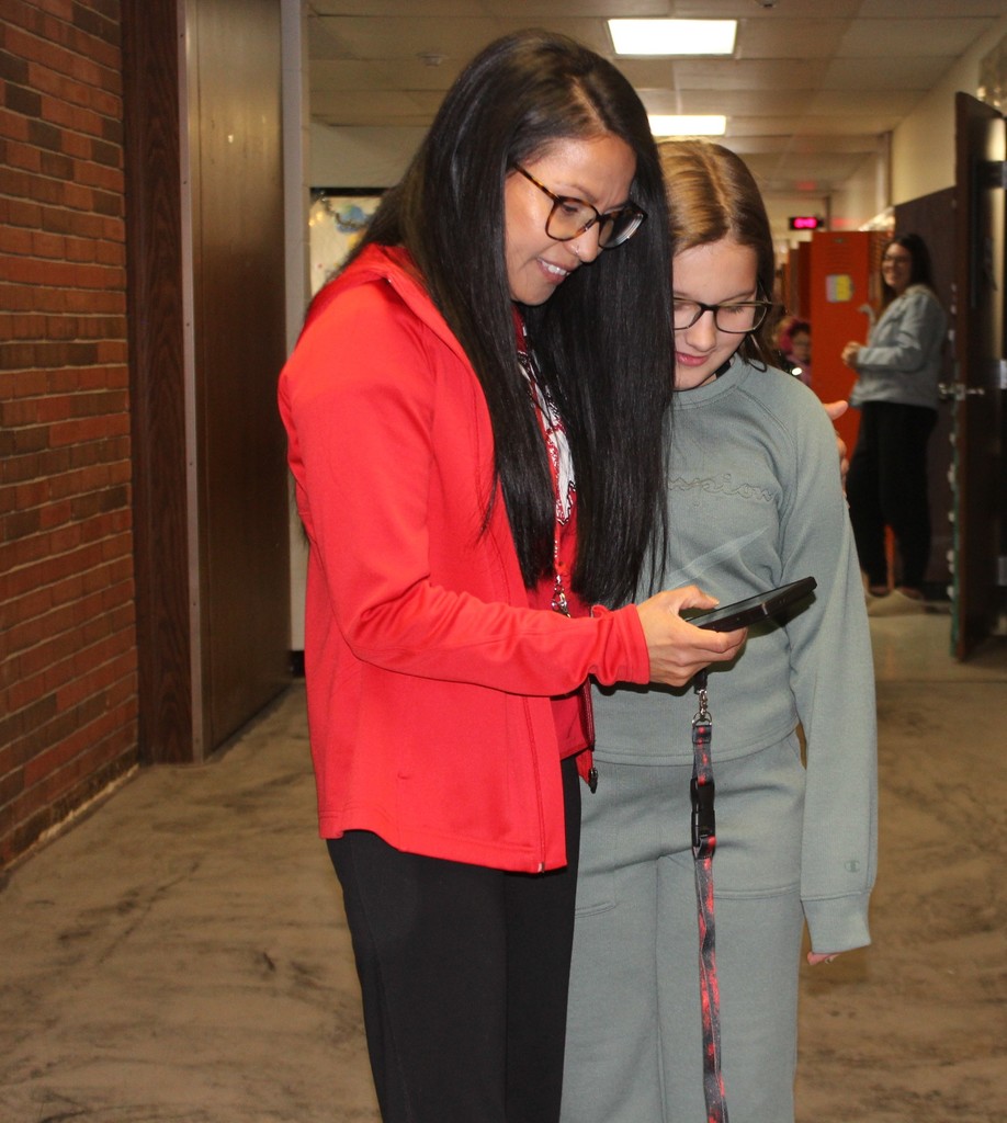 Maria Lozoya with a student checking the good morning counts.  