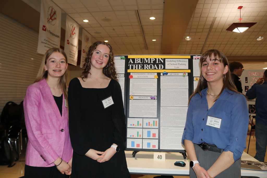 This is a photo from last year's science day with three students who continue to share their research.  