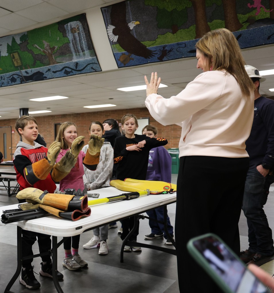 Students try on gloves used by linemen.  
