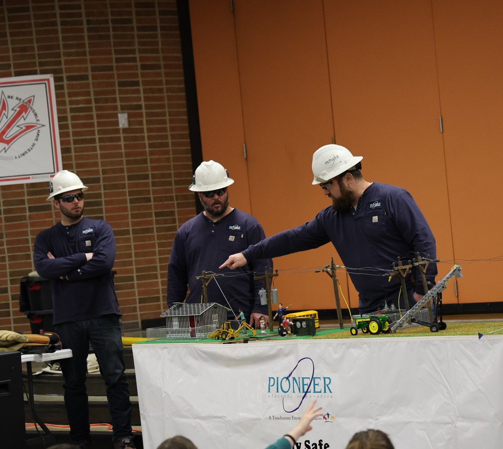 Linemen with Pioneer Electric Cooperative teach L.T. Ball students about electricity and safety.  
