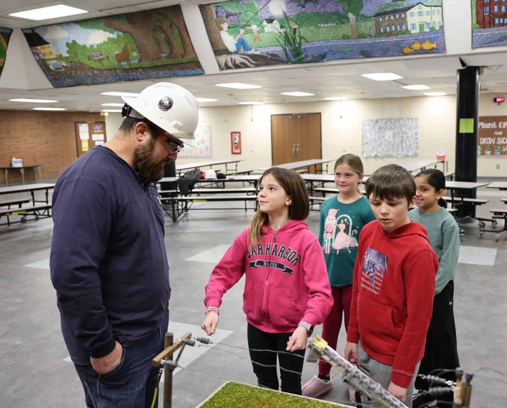 Lineman with Pioneer Electric Cooperative answer questions L.T. Ball students about electricity and safety. 