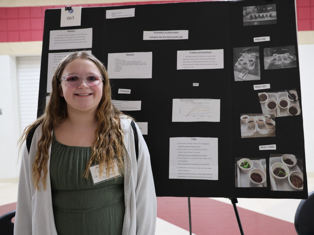 Tippecanoe Middle School student poses with her project at Miami County Science Day.