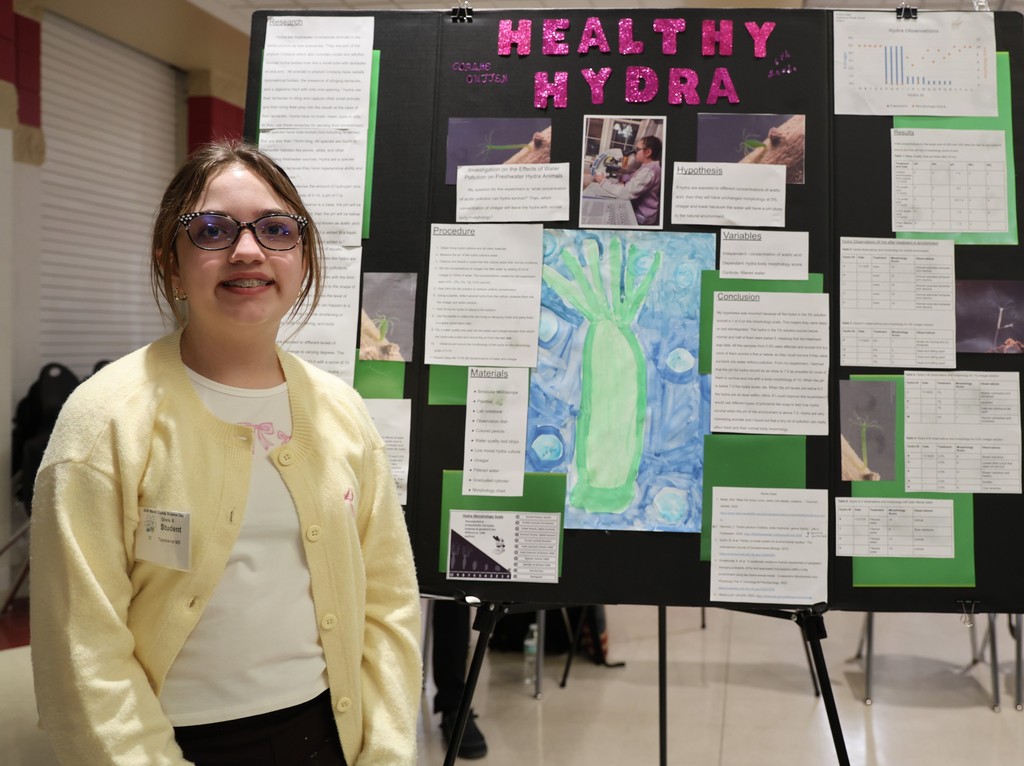 Tippecanoe Middle School student poses with her project at Miami County Science Day.