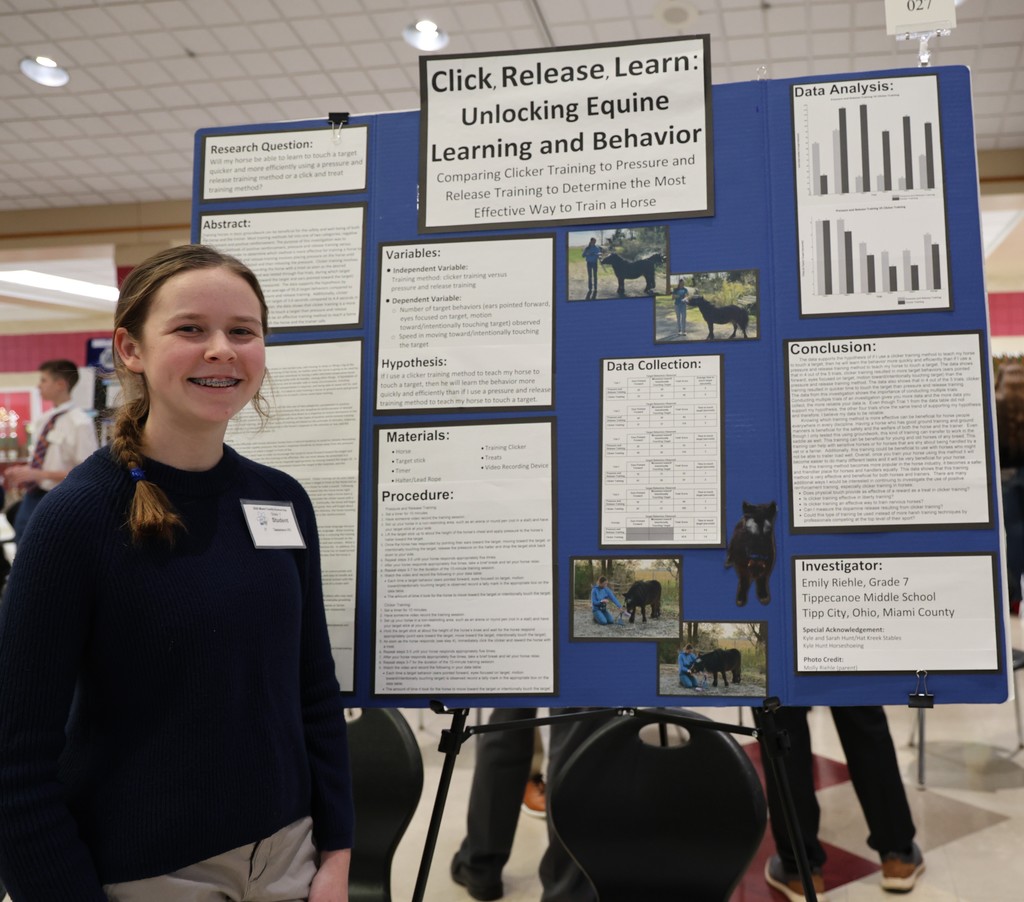 Tippecanoe Middle School student poses with her project at Miami County Science Day.