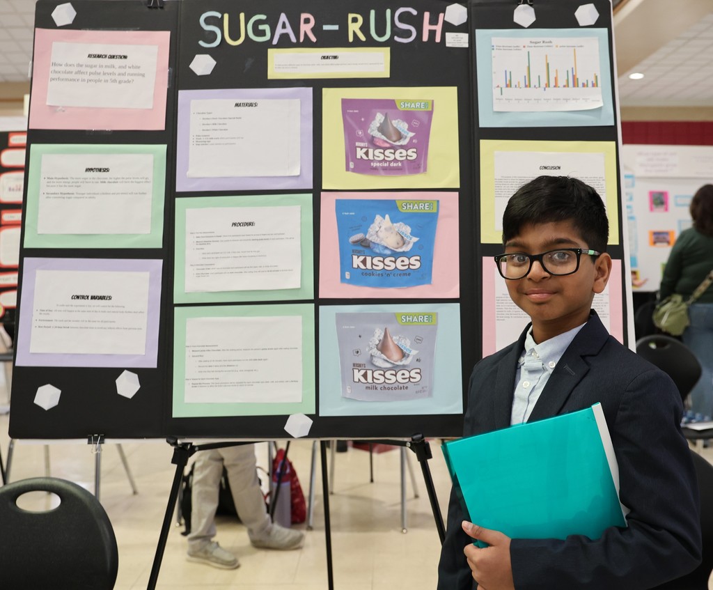 Tippecanoe Middle School student poses with her project at Miami County Science Day.