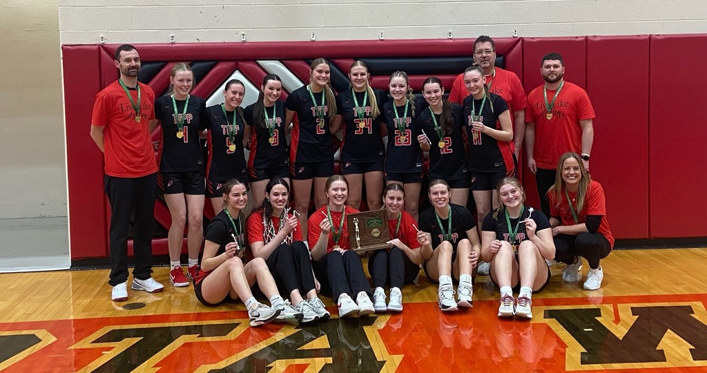 THS girls basketball team with their medals and trophy after winning their game to become district champions.