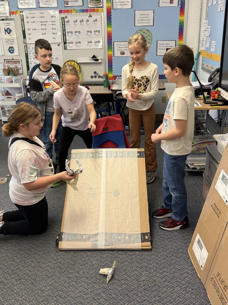 Students test their skier made out of foil as part of a stem project on speed and motion.