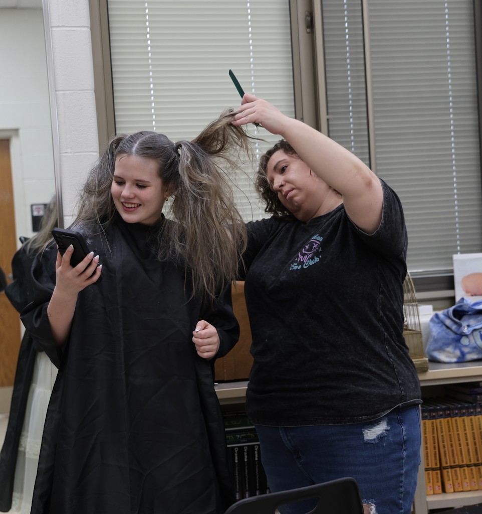Getting ready with hair and makeup behind the scenes.