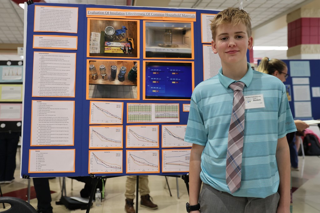 A student from L.T. Ball stands with his project board at Miami County Science Day.