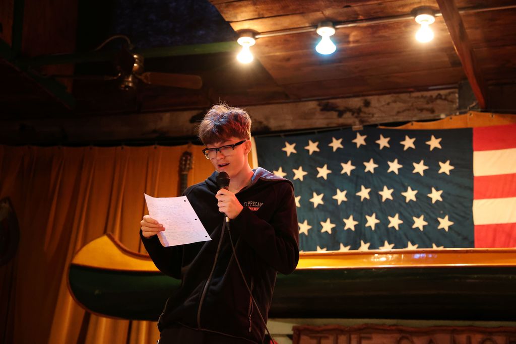A student reads his work at Night Write.