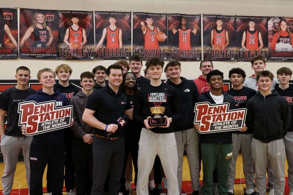 THS senior surrounded by student athletes as he gets awarded as Penn Station Athlete of the Month.