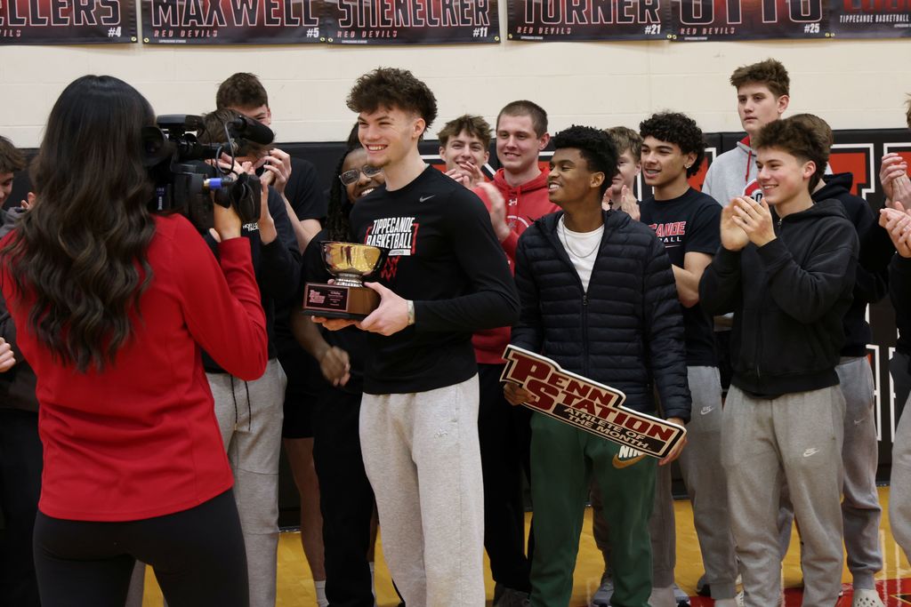 THS senior surrounded by student athletes as he gets awarded as Penn Station Athlete of the Month.