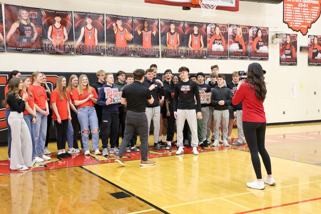 THS senior surrounded by student athletes as he gets awarded as Penn Station Athlete of the Month.