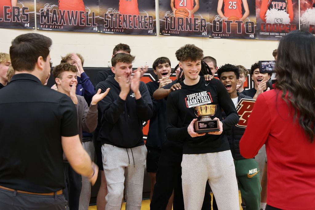 THS senior surrounded by student athletes as he gets awarded as Penn Station Athlete of the Month.