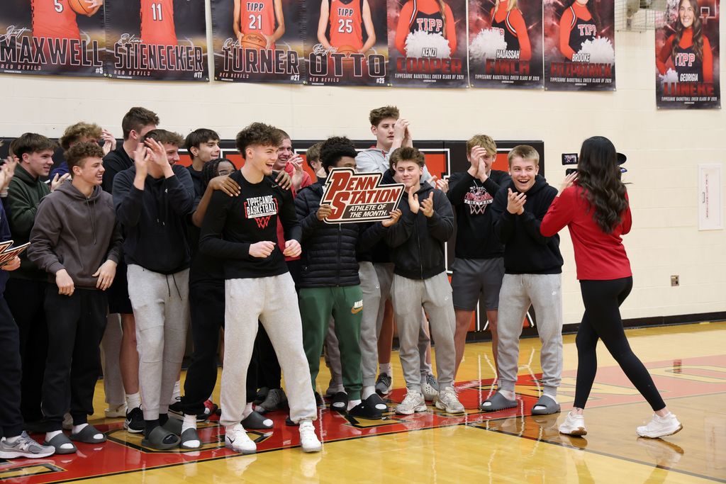 THS senior surrounded by student athletes as he gets awarded as Penn Station Athlete of the Month.