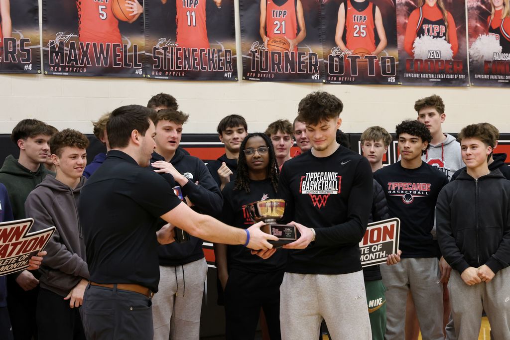 THS senior surrounded by student athletes as he gets awarded as Penn Station Athlete of the Month.