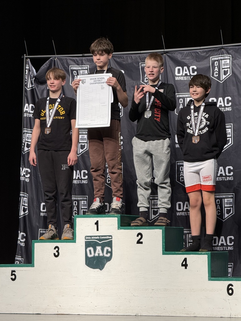A student on the podium for his second place win. 