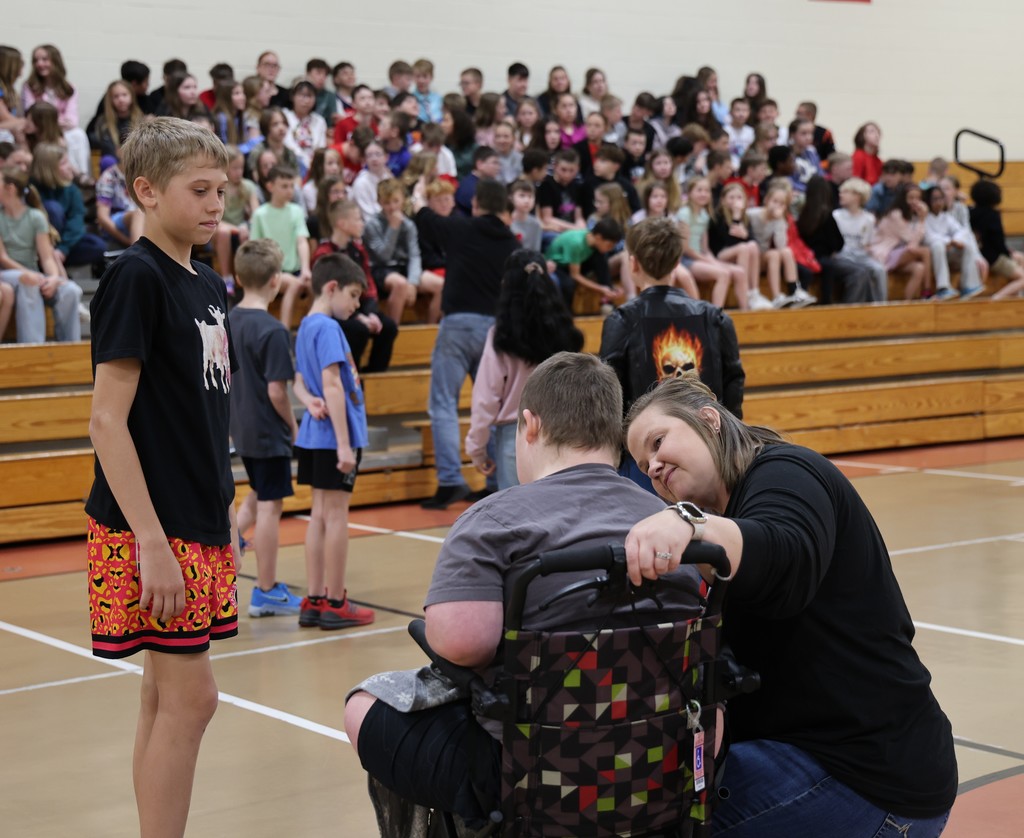 An LT Ball students is encouraging his classmate to join the group picture.