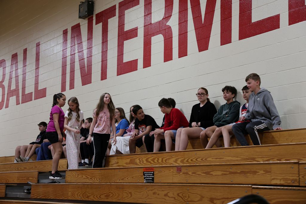 Students start filling the bleachers.